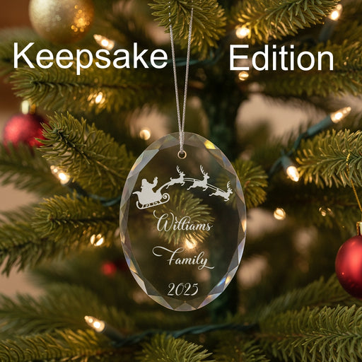 Crystal Christmas ornament with Santa and reindeer sleigh design with engraved lettering and year, on a green background, labeled 'Keepsake Edition'.