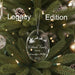 Crystal Christmas ornament with Santa and reindeer sleigh design, engraved lettering , engraved handwritten note, and engraved year, on a green background, labeled 'Legacy Edition.