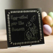 Granite tile with an engraving of Egg-cited for the Season,' and a bunny on the top left and bottom right corners respectively, all surrounded by an Easter Egg border.