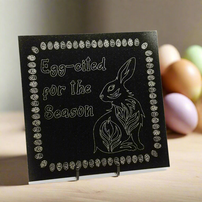 Granite tile with an engraving of Egg-cited for the Season,' and a bunny on the top left and bottom right corners respectively, all surrounded by an Easter Egg border.
